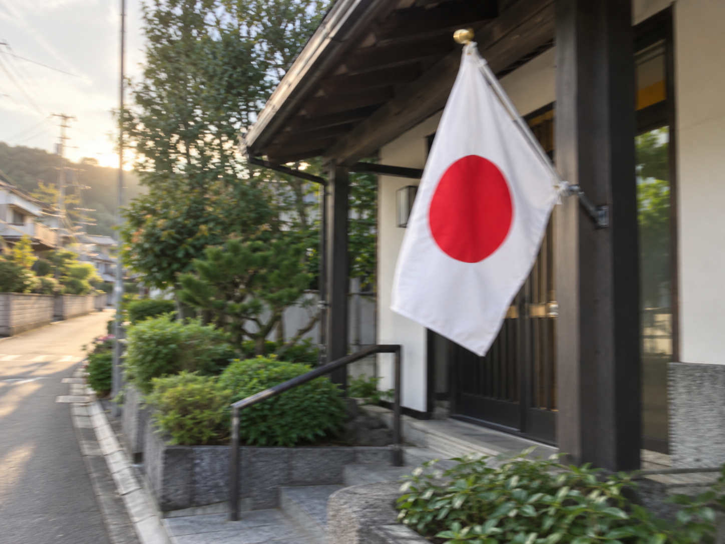 A slightly blurred photo of the Japanese flag outside a neighborhood building